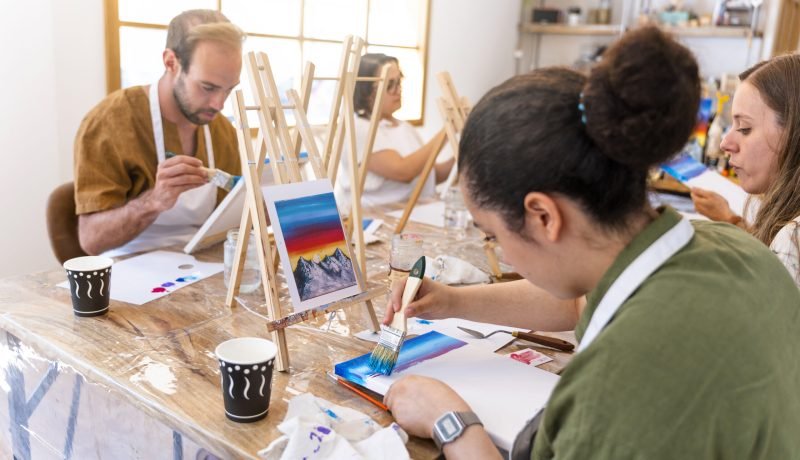 Art and Wine Workshop. Friends painting while tasting different wines.